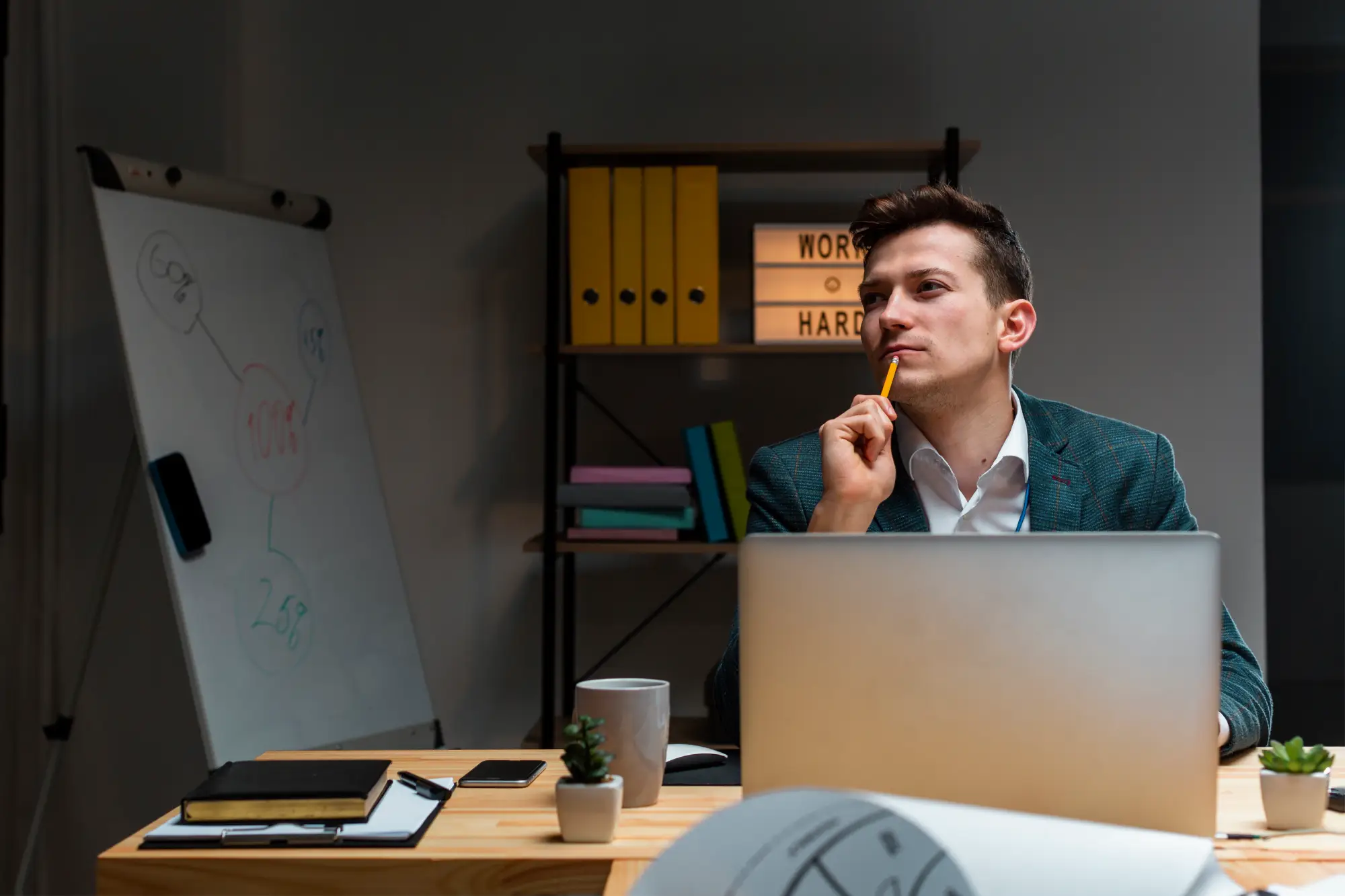 Man thinking at desk representing employment agency scams and fake job offers