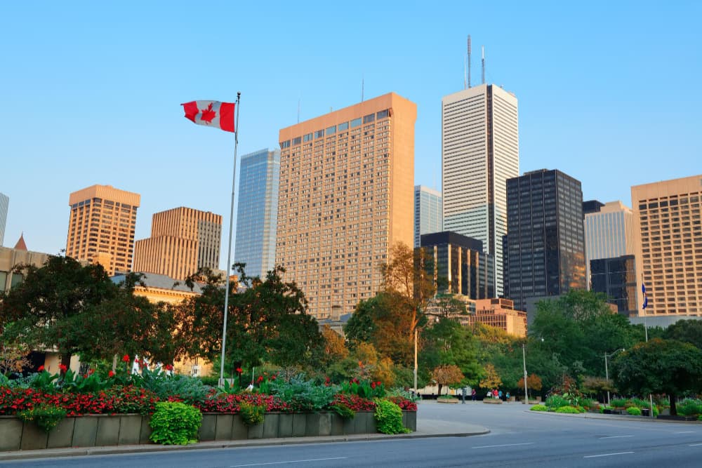 Toronto skyline and Canadian flag illustrating the 2025 CEC draw results for Canadian Experience Class applicants.
